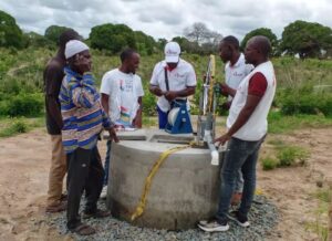 View of the MSF team checking one of the safeguarded wells equipped with hand pump systems built by MSF to facilitate access to water for the communities. MSF/Lourino Pelembe