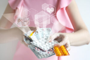 Woman is holding medicines. Flying hologram with medical icons. Pharmaceutical, Healthcare, Pharmacy Concept. 