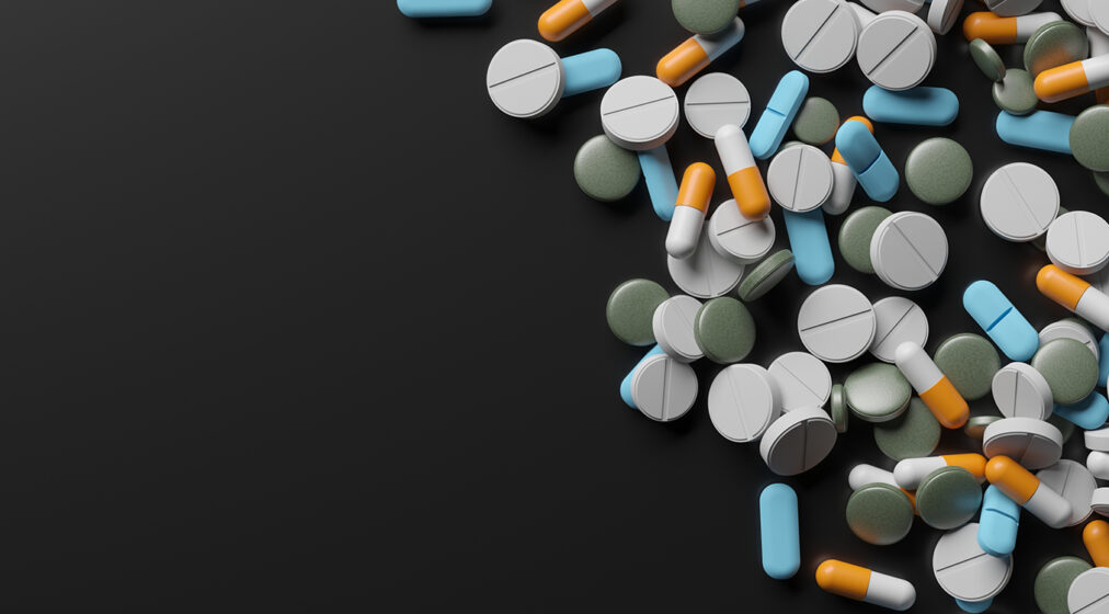 Different medicines on surface. Assorted pharmaceutical pills. 3d rendering