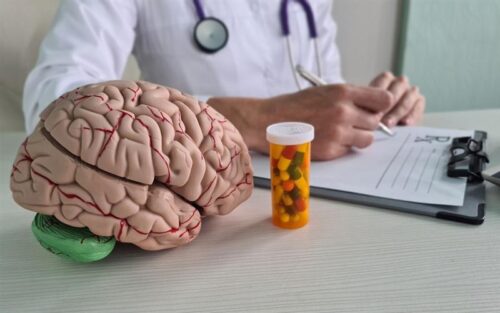 Neurologist writes prescription for neuropsychiatric pills. Medicines for memory and neural connections in brain.