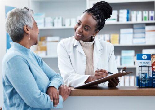 Pharmacy, healthcare or insurance with a customer and black woman pharmacist in a dispensary. Medical, clipboard and trust with a female medicine professional helping a patient in a drugstore.