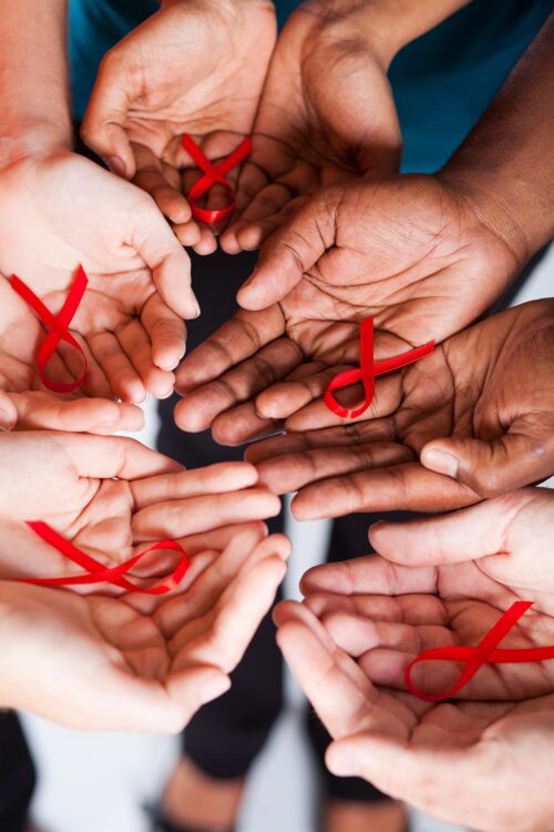 Hands holding HIV ribbon